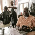 A Man Sitting on a Barber Chair